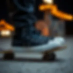A pair of black All Star Converse sneakers on a skateboard