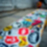 A collection of vibrant box logo stickers displayed on a skateboard, showcasing various designs and colors.