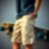 Stylish khaki board shorts displayed against a skateboard