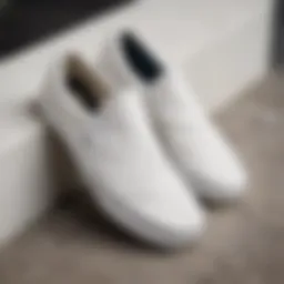 Close-up view of white canvas Vans slip-ons showcasing their design details