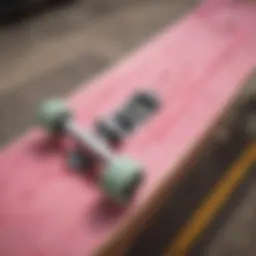A vintage skateboard deck showcasing old skool pink artwork