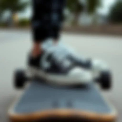 Classic black and white Converse sneakers on a skateboard